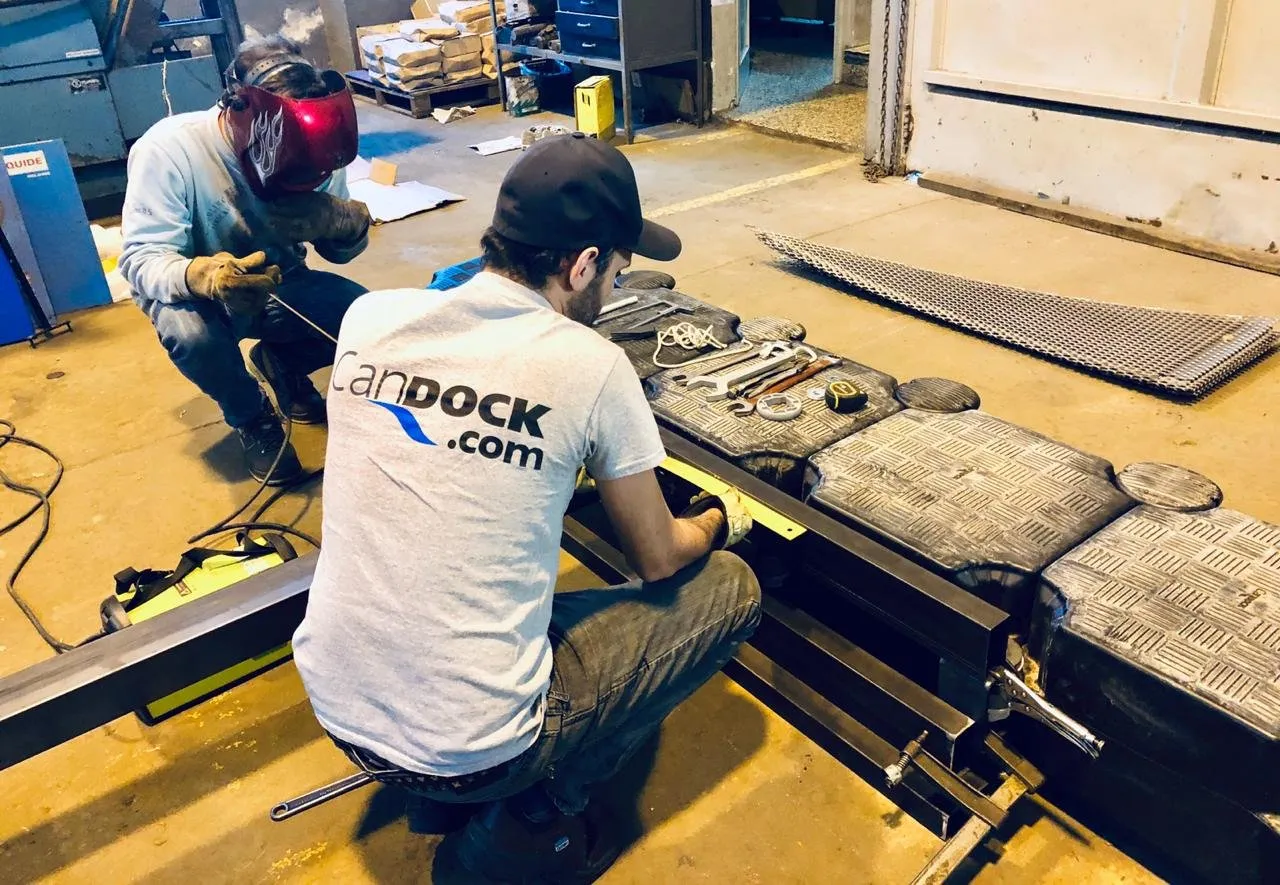 Técnicos de Candock trabajando en una pasarela de aluminio en el taller